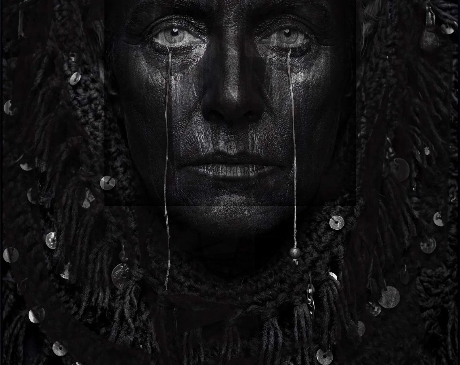 Matteo Basilé, portrait from the Magnifica Humanitas series: a black-and-white face with two tears